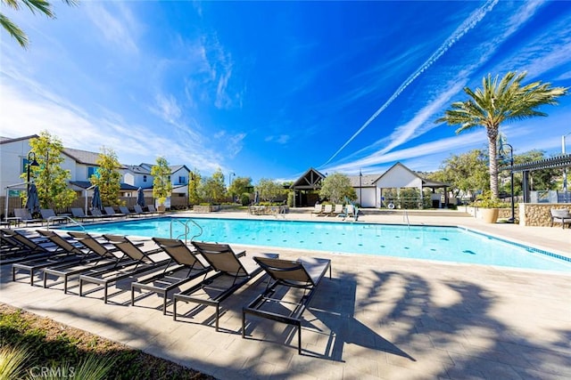 view of swimming pool with a pergola and a patio area