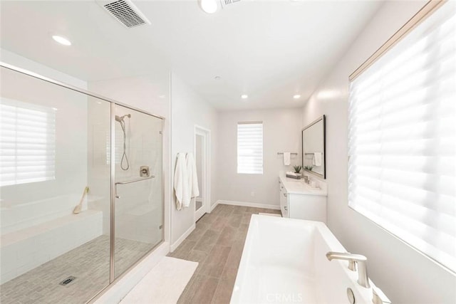 bathroom featuring vanity and a shower with door