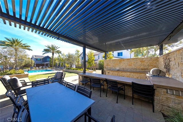 view of patio / terrace with area for grilling, an outdoor bar, and exterior kitchen