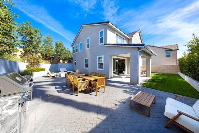 back of house with a patio and area for grilling