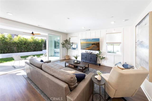 living room with a healthy amount of sunlight and dark hardwood / wood-style flooring