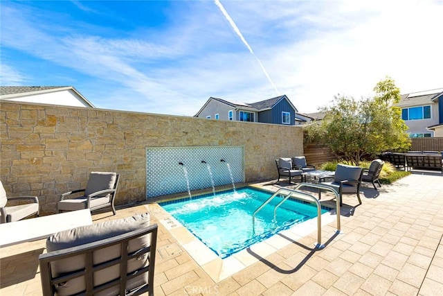 view of swimming pool featuring a patio area