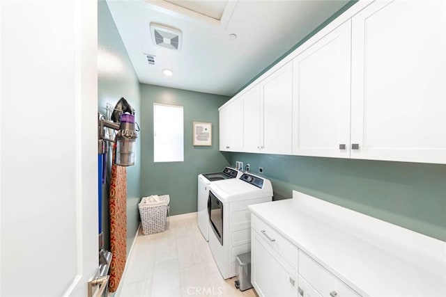 laundry area featuring cabinets and independent washer and dryer