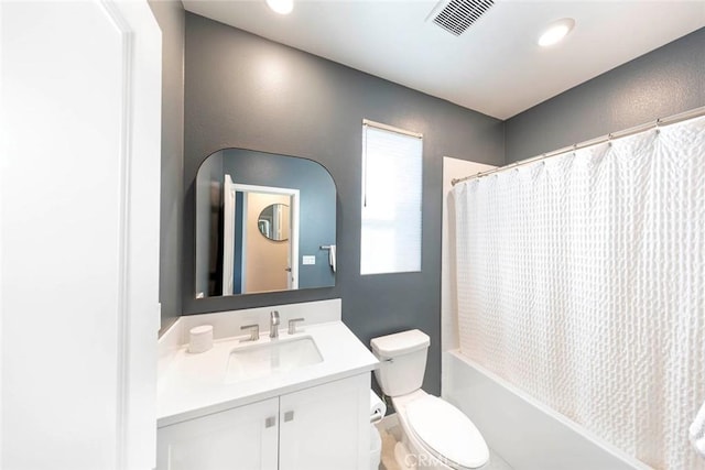 full bathroom with vanity, shower / bath combo, and toilet