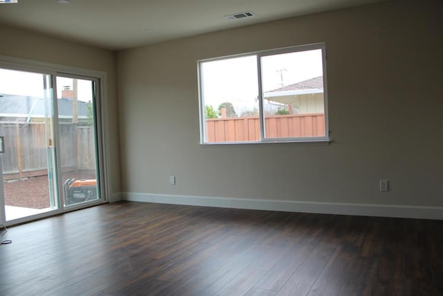 unfurnished room featuring dark hardwood / wood-style flooring