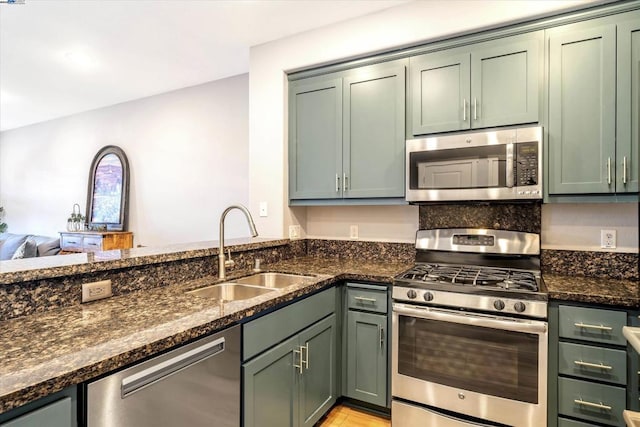 kitchen featuring green cabinetry, appliances with stainless steel finishes, and sink