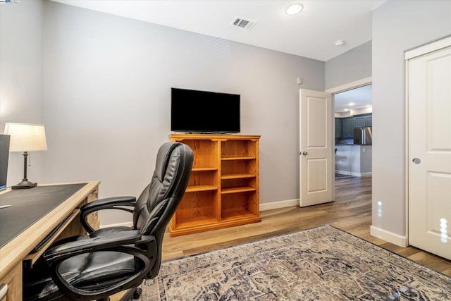 office with light hardwood / wood-style flooring