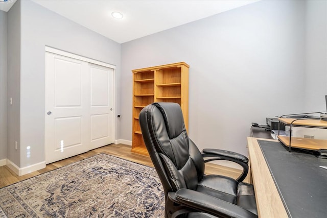 office area with light hardwood / wood-style floors