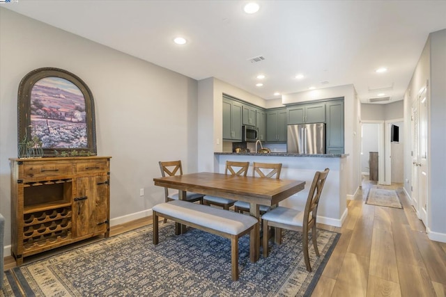 dining space with hardwood / wood-style flooring