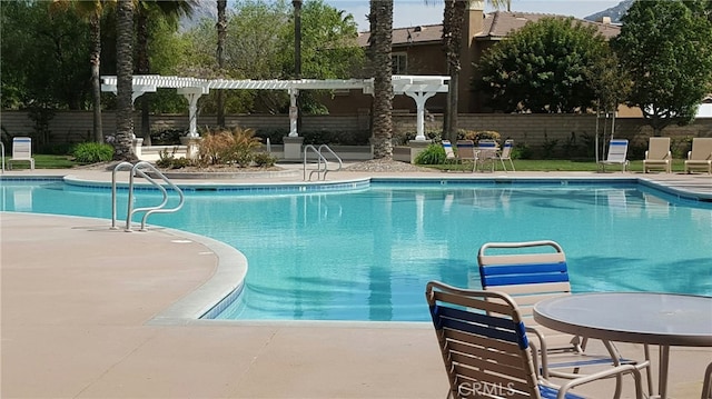 view of pool featuring a pergola and a patio