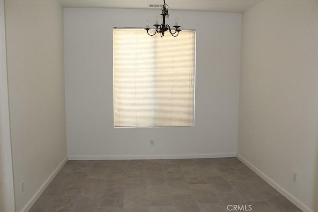 unfurnished room with an inviting chandelier