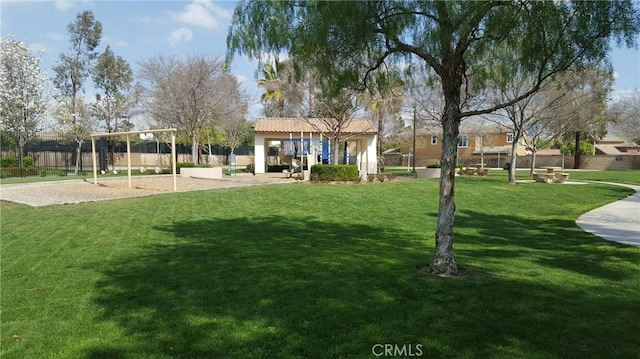 view of property's community featuring a yard and a playground