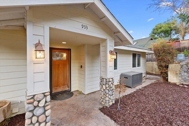 entrance to property featuring fence