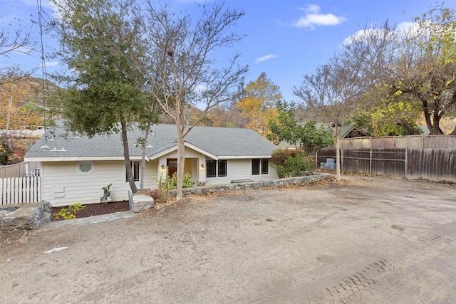 view of front of home featuring fence