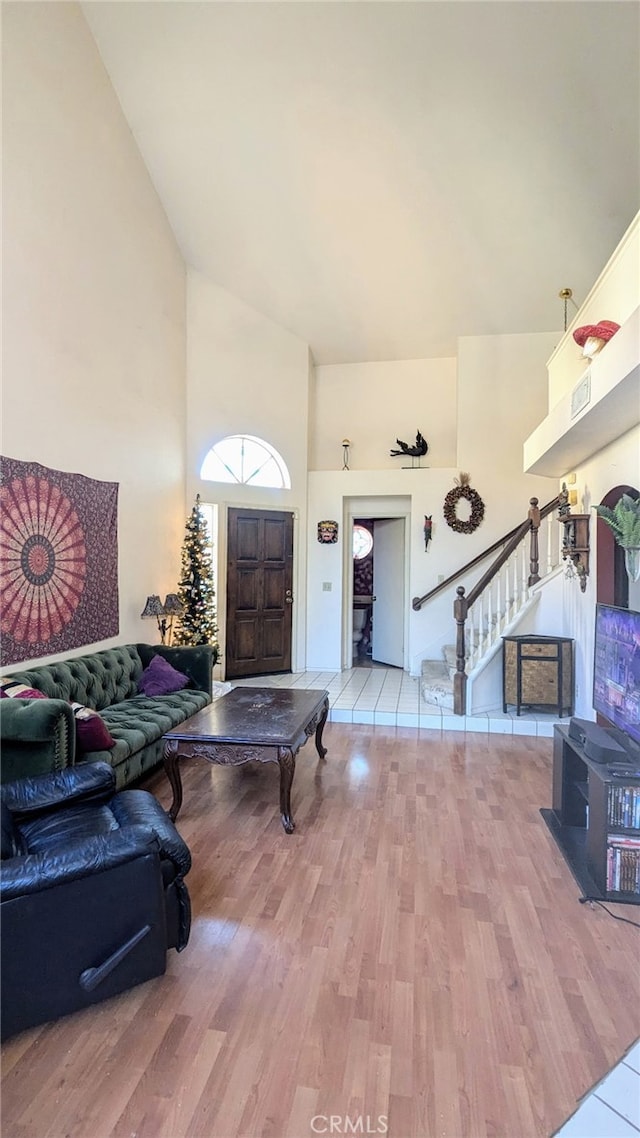 foyer with hardwood / wood-style floors and a high ceiling