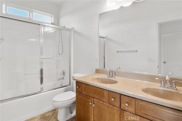 30272 Tattersail Way, Menifee, CA 92584 - full bath featuring toilet, double vanity, shower / bath combination with glass door, and tile patterned floors