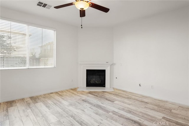 30272 Tattersail Way, Menifee, CA 92584 - unfurnished living room featuring a ceiling fan, a glass covered fireplace, and wood finished floors