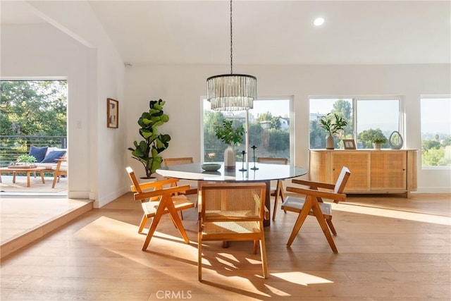 dining room with light wood finished floors, a notable chandelier, recessed lighting, and baseboards