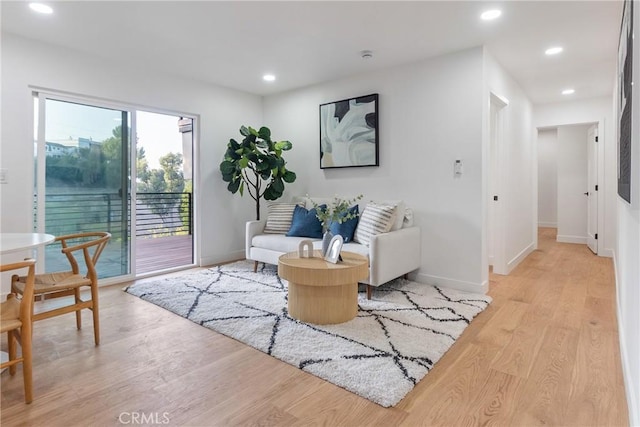 living area featuring recessed lighting, light wood-type flooring, and baseboards