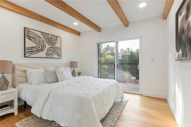 bedroom featuring access to outside, light wood-style flooring, beamed ceiling, and baseboards