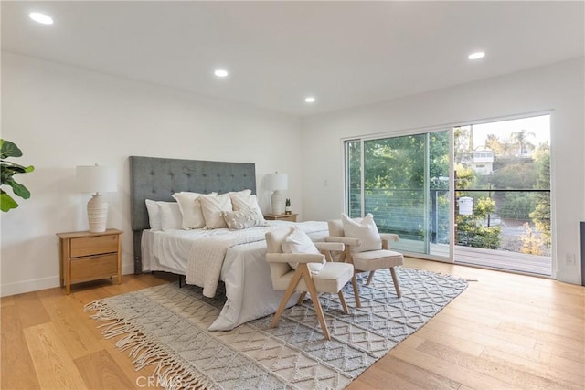 bedroom with recessed lighting, wood finished floors, and access to exterior