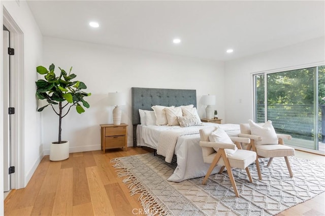 bedroom featuring recessed lighting, light wood-type flooring, baseboards, and access to exterior