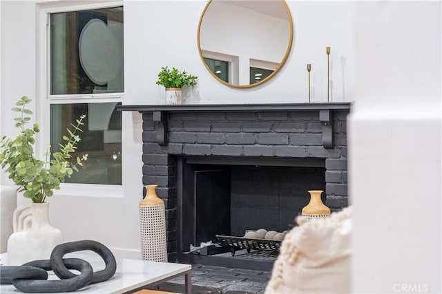 interior details with a brick fireplace