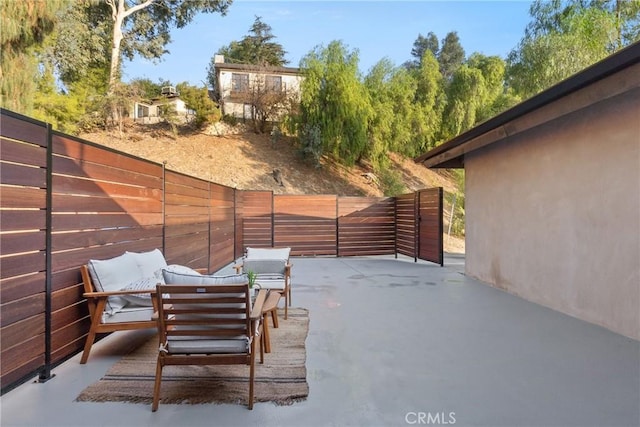 view of patio with an outdoor living space and a fenced backyard