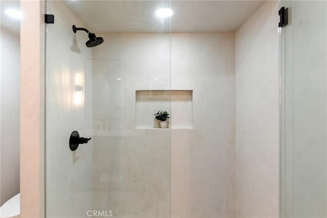 details featuring toilet and walk in shower