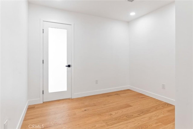 unfurnished room with light wood-style flooring, recessed lighting, and baseboards