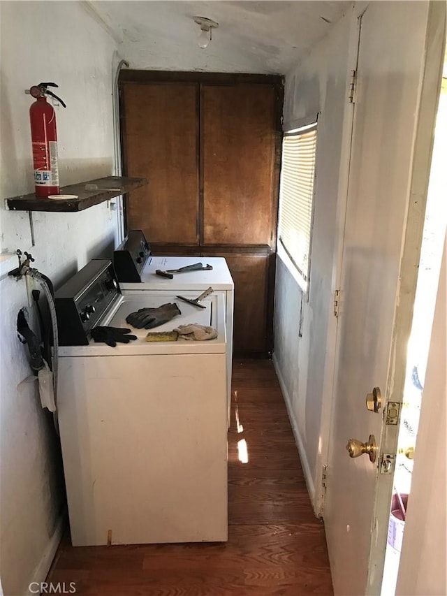 kitchen with dark hardwood / wood-style floors and washing machine and dryer