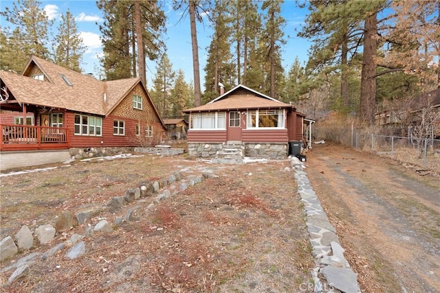 1149 Apple Ave, Wrightwood, CA 92397 - view of front of house featuring dirt driveway, fence, and roof with shingles