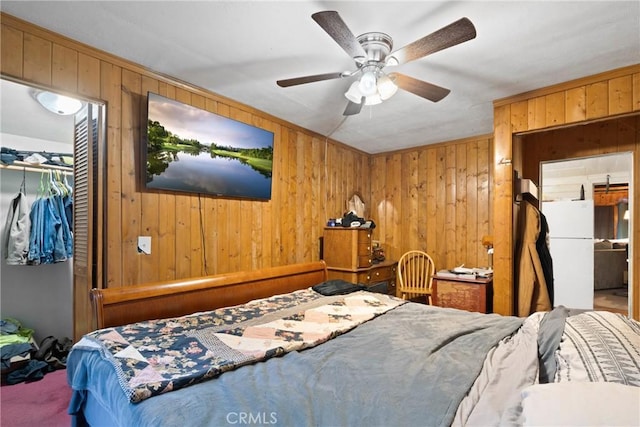 1149 Apple Ave, Wrightwood, CA 92397 - carpeted bedroom featuring wooden walls, a closet, ceiling fan, and freestanding refrigerator