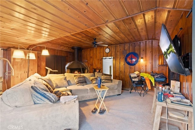 1149 Apple Ave, Wrightwood, CA 92397 - living area featuring wooden ceiling, light carpet, wood walls, and a wood stove