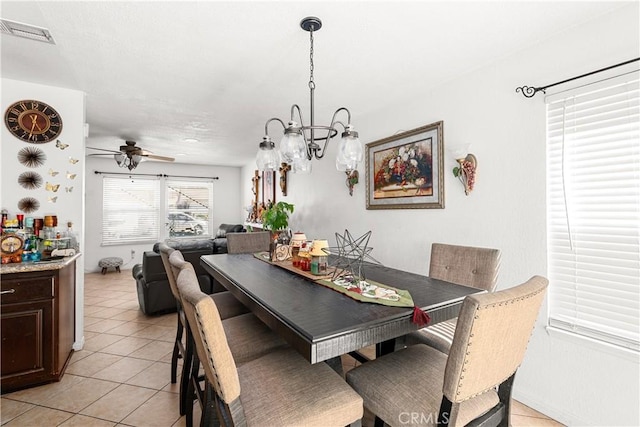 tiled dining room featuring ceiling fan