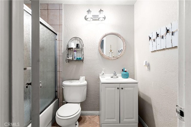 full bathroom with enclosed tub / shower combo, vanity, and toilet