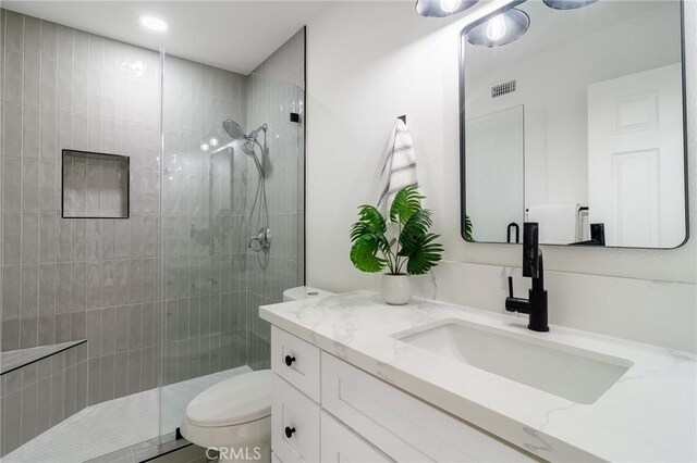 full bathroom featuring visible vents, toilet, and a walk in shower