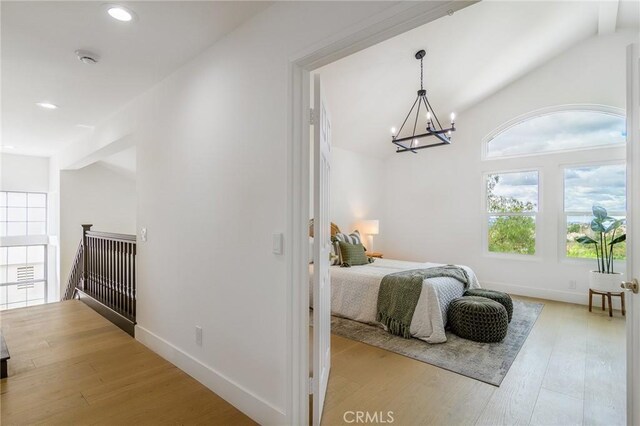 bedroom with recessed lighting, baseboards, lofted ceiling, and light wood-style floors