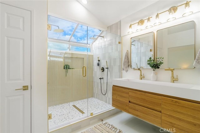 bathroom with tile patterned flooring, a shower stall, double vanity, vaulted ceiling, and a sink