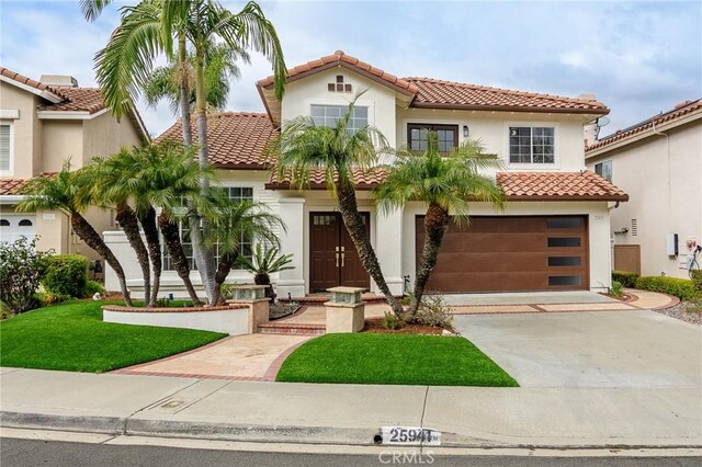 mediterranean / spanish home with stucco siding, driveway, a tile roof, and an attached garage