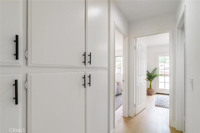 hallway with light wood-type flooring