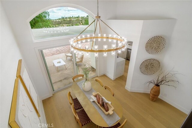 details featuring wood finished floors, baseboards, and a chandelier