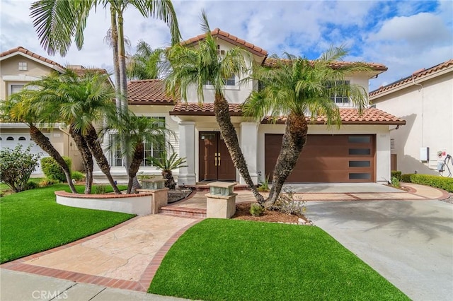 mediterranean / spanish-style house featuring a garage and a front yard