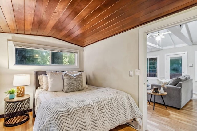 bedroom featuring lofted ceiling, light hardwood / wood-style flooring, and wooden ceiling