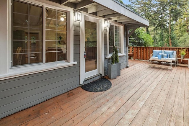 wooden terrace featuring an outdoor hangout area