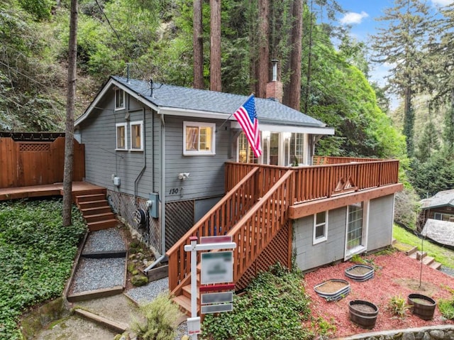 rear view of house featuring a deck