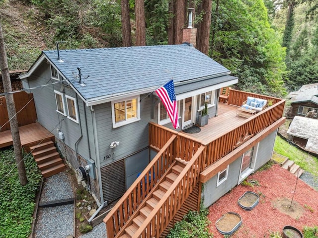 exterior space featuring a wooden deck and outdoor lounge area