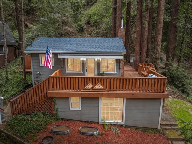 back of property featuring a wooden deck