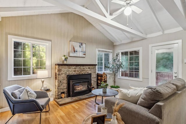 living room with hardwood / wood-style flooring, ceiling fan, and lofted ceiling with beams