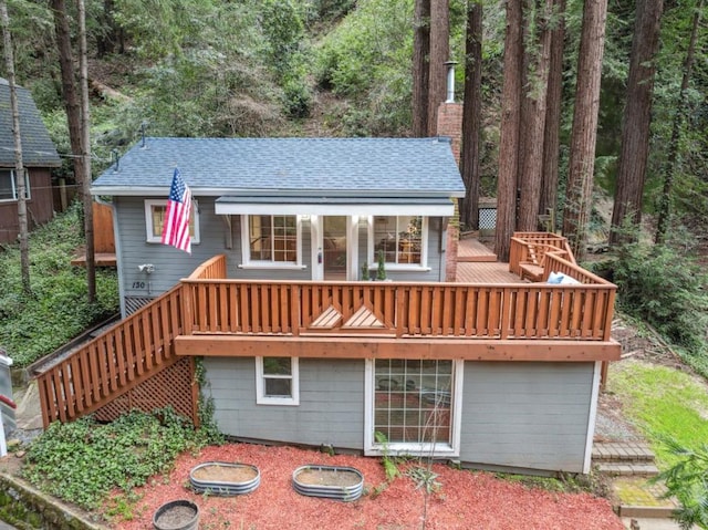 back of house featuring a wooden deck